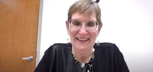 white woman with short blonde hair and glasses