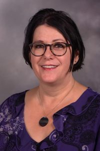 portrait: white woman with dark brown hair and glasses