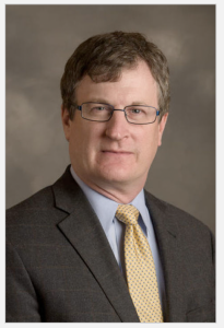 white man with brown hair and glasses