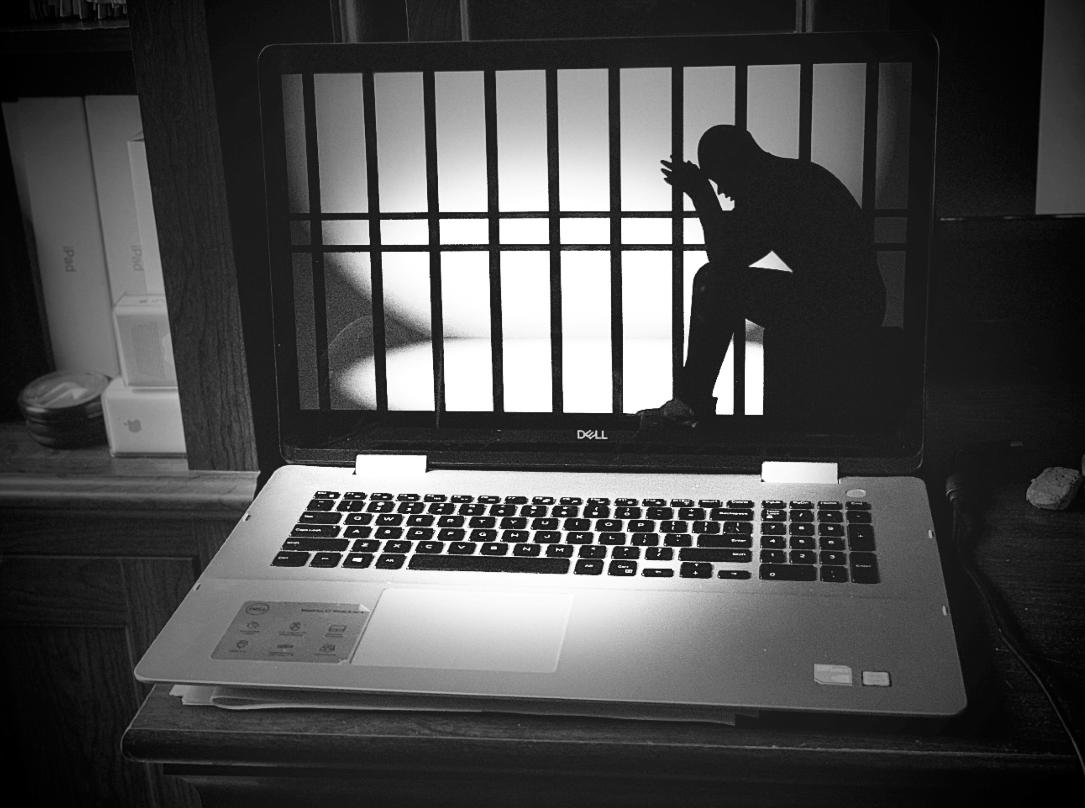 laptop image: man behind bars