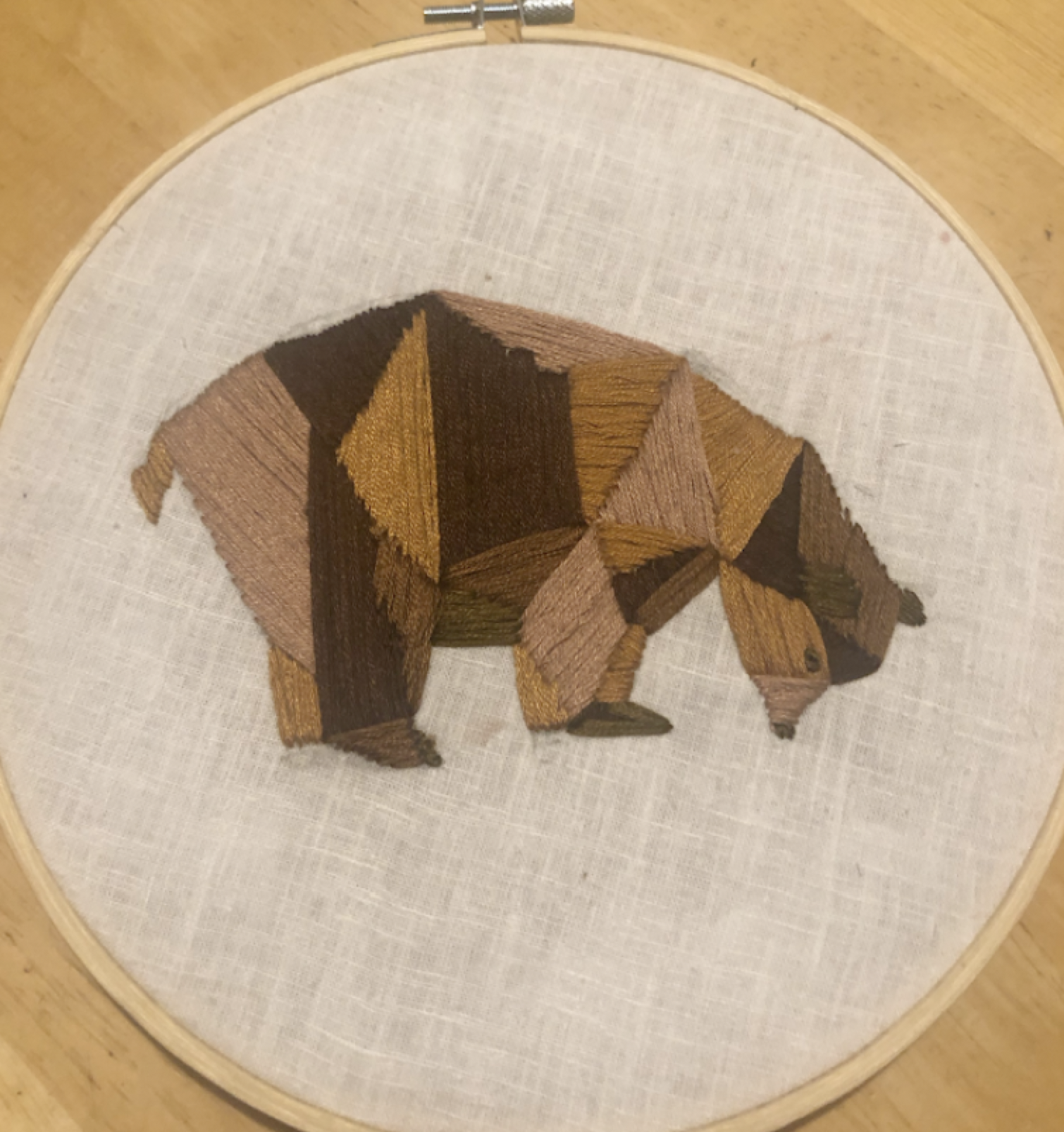 embroidery of bear sniffing ground